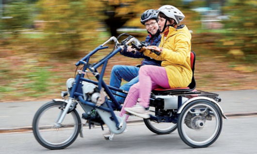 Bild Stiftung Domino als Arbeitgeberin mit zwei Menschen auf einem Tandemvelo